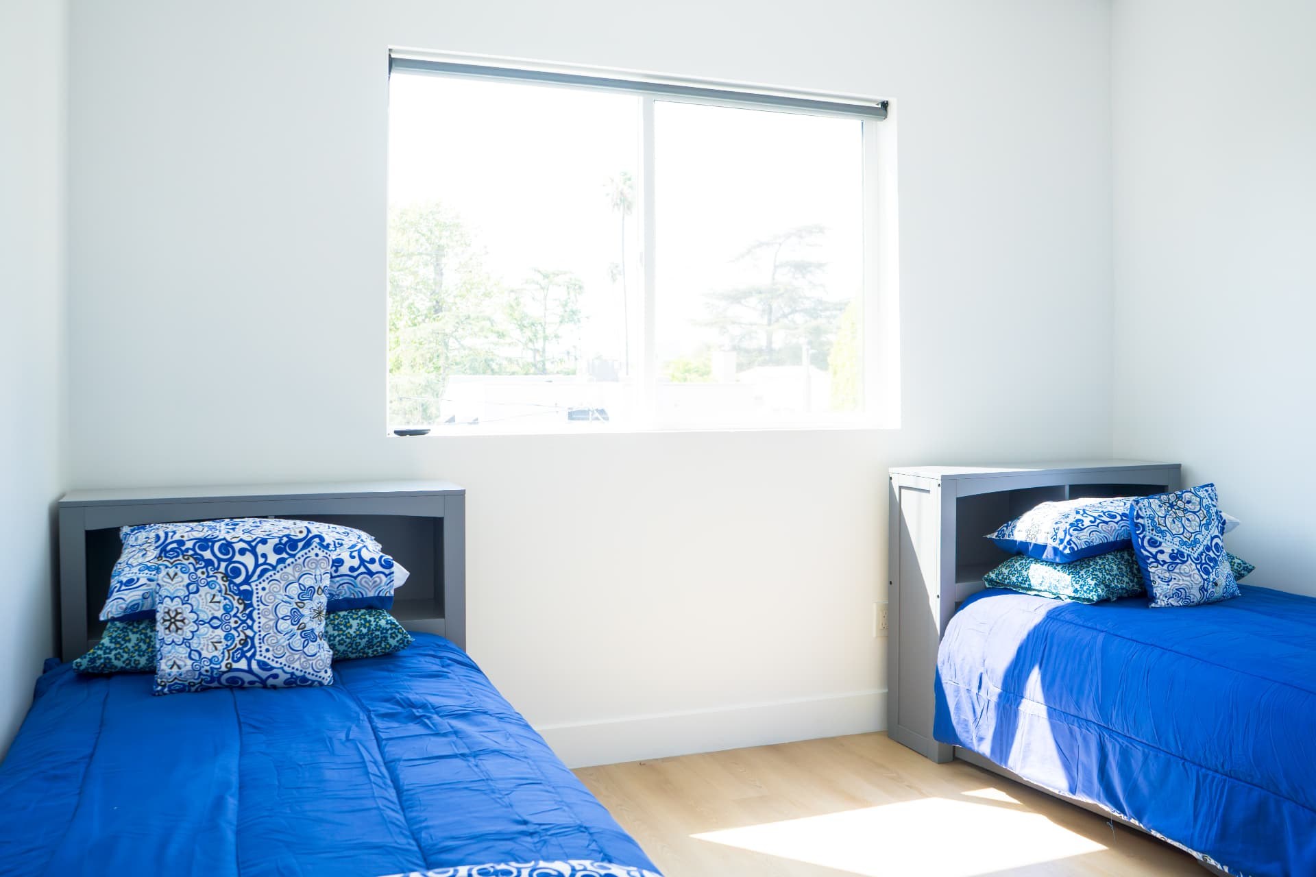 Shared bedroom with twin beds and bright blue bedding
