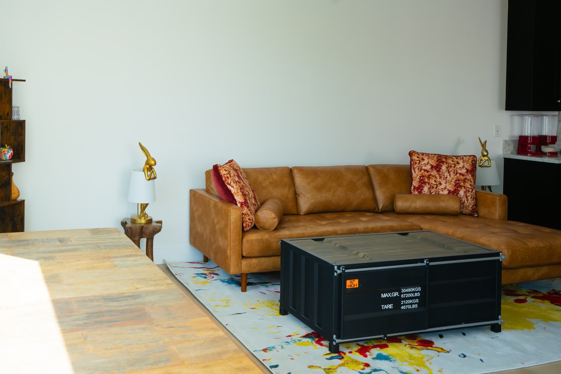 Shared living and dining area with a leather sofa and black coffee table